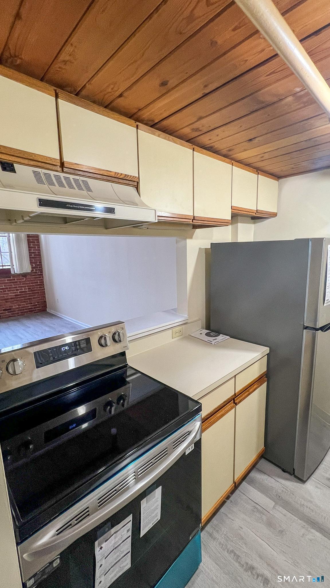 839 Main Street, Unit 68 Torrington, CT 06790 - Photo 10 of 20 a stove top oven sitting inside of a kitchen