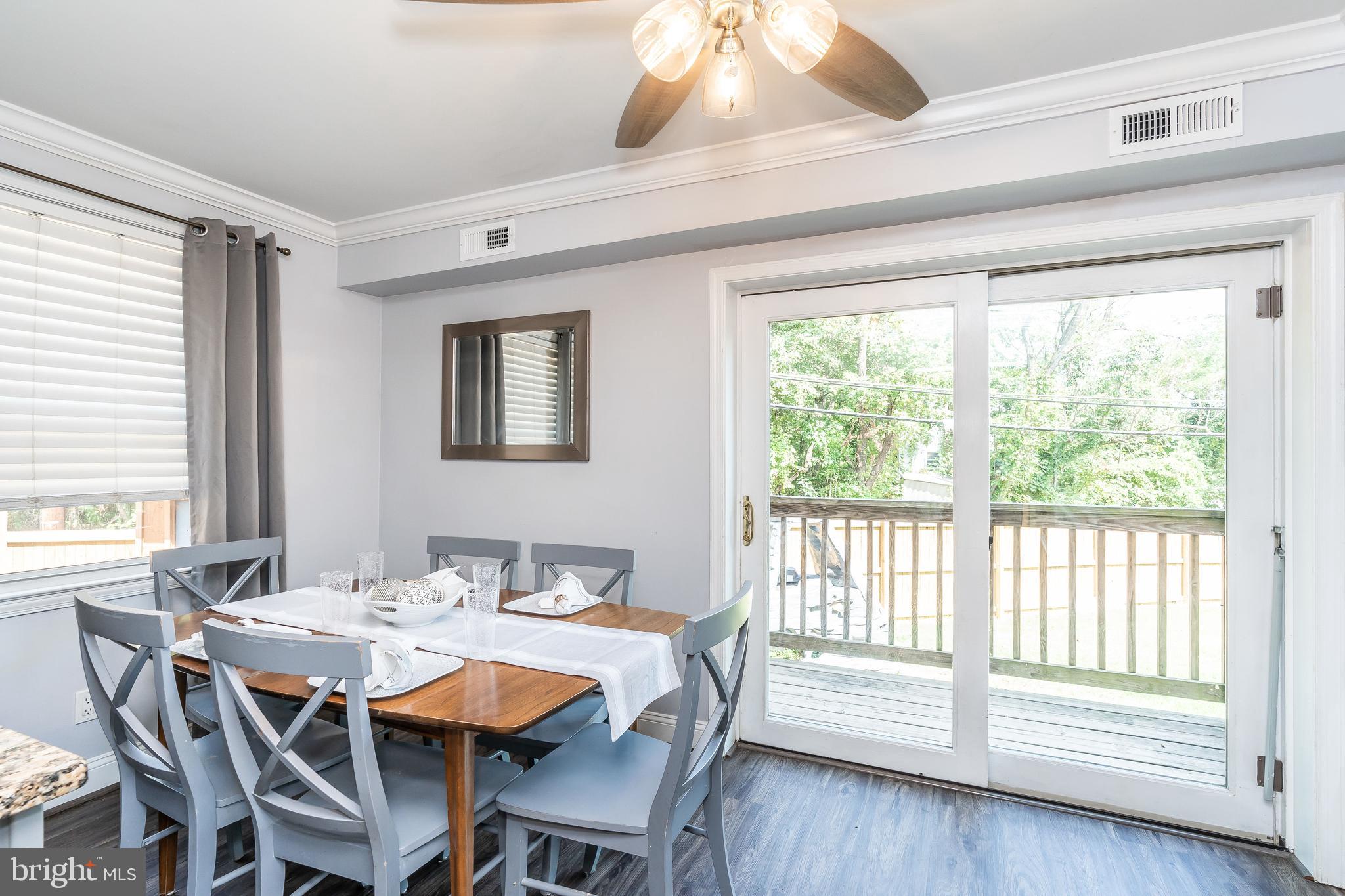 1224 Elm Road Baltimore, MD 21227 - Photo 8 of 36 Dining room opens up to sliding door to the deck.