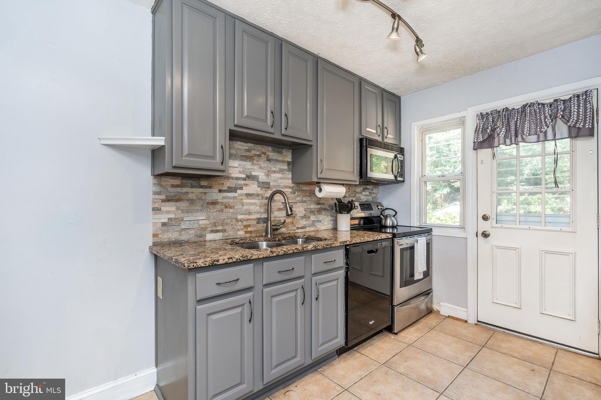 1224 Elm Road Baltimore, MD 21227 - Photo 10 of 36 Tile flooring and maple cabinets.