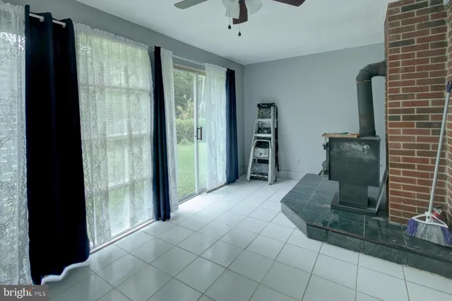 a view of kitchen with furniture and refrigerator