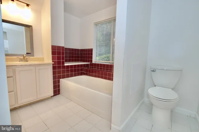 a bathroom with a sink a toilet and bathtub
