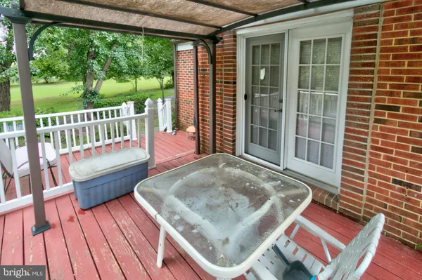 a view of deck with a table and chairs