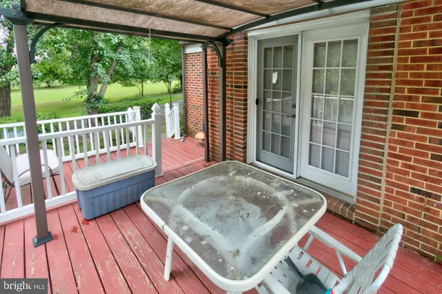 a view of deck with a table and chairs