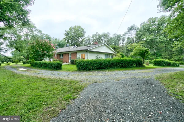 a view of a house with yard and a garden