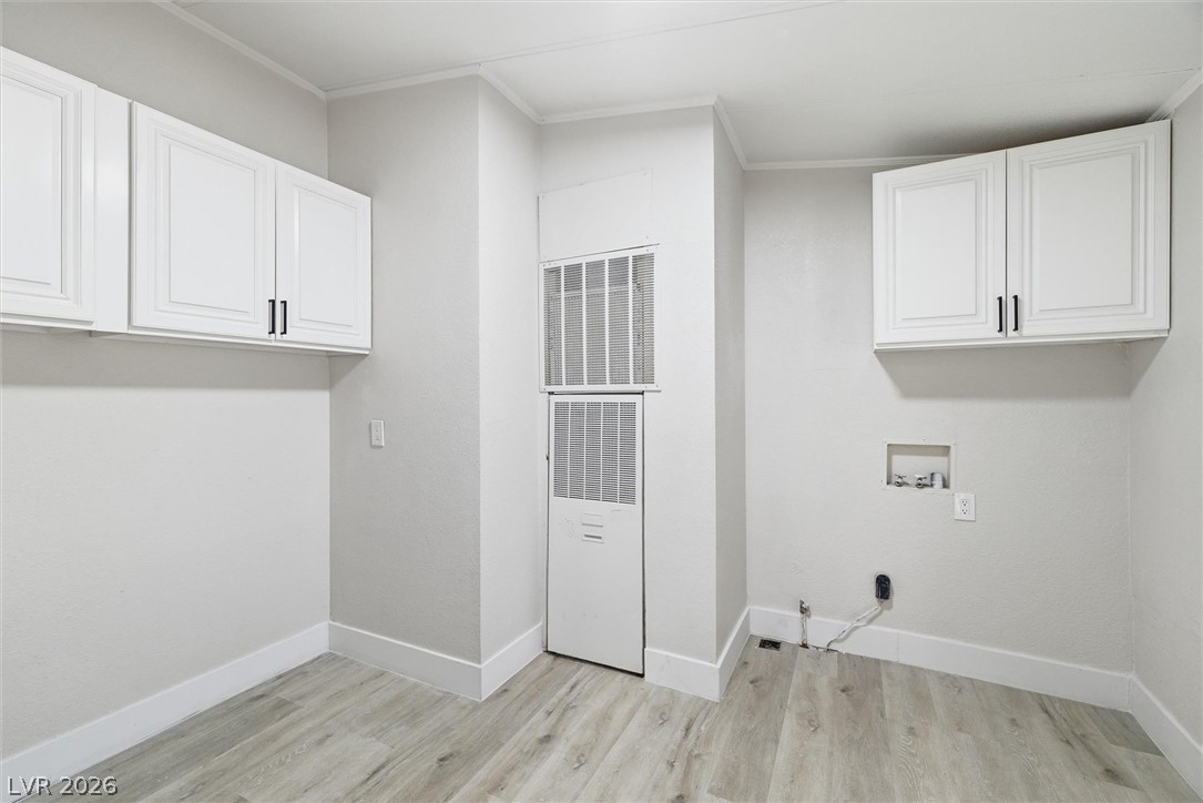 3940 Point Drive Pahrump, NV 89060 - Photo 19 of 35 Ample overhead cabinetry enhances this bright, functional laundry room, ready for your appliances.
