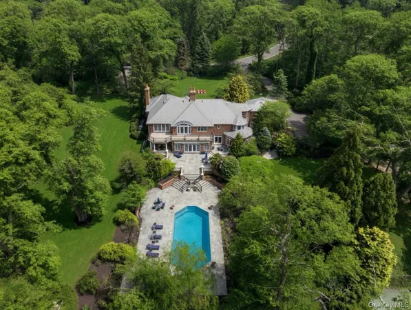 an aerial view of a house with yard swimming pool and outdoor seating