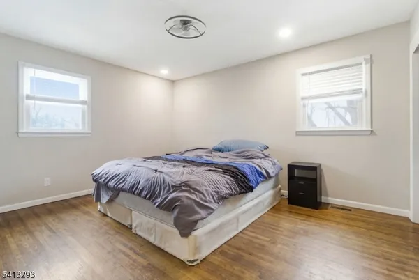 a bed sitting in a bedroom next to a window
