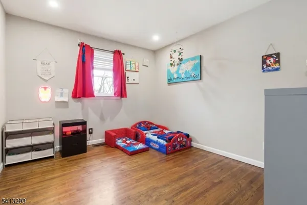 a bedroom with furniture and a wooden floor