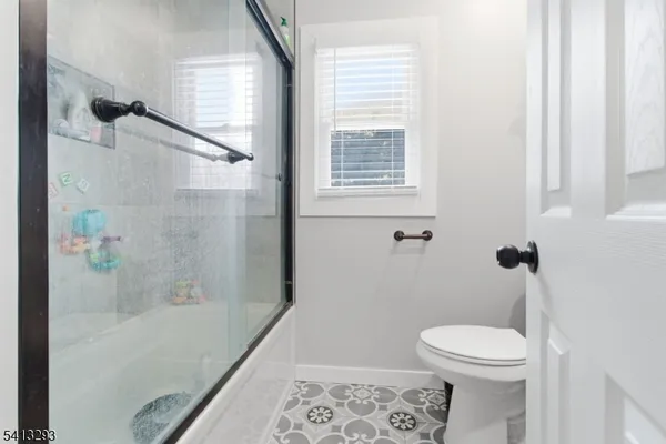 a bathroom with a toilet and a shower