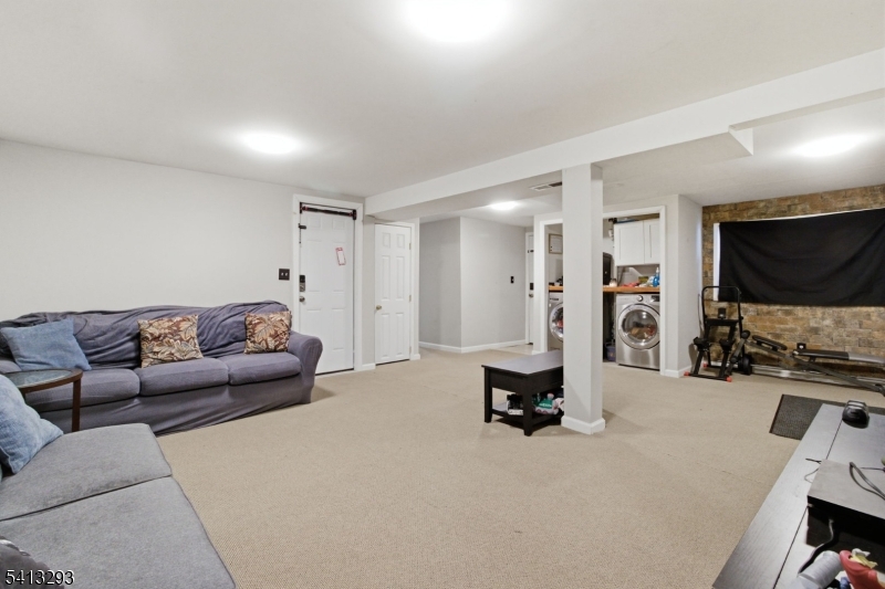 3 Gardenia Road Vernon, NJ 07418 - Photo 16 of 22 a living room with furniture and a flat screen tv