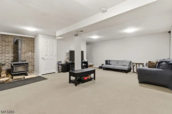 a living room with furniture gym equipment and a flat screen tv