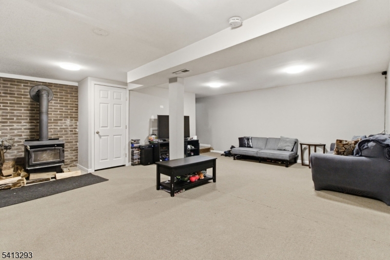 3 Gardenia Road Vernon, NJ 07418 - Photo 17 of 22 a living room with furniture gym equipment and a flat screen tv