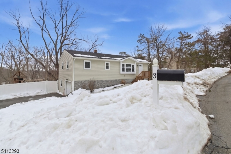 3 Gardenia Road Vernon, NJ 07418 - Photo 4 of 22 a view of a house with a yard covered in snow