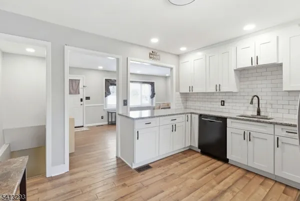 a large kitchen with a sink and cabinets