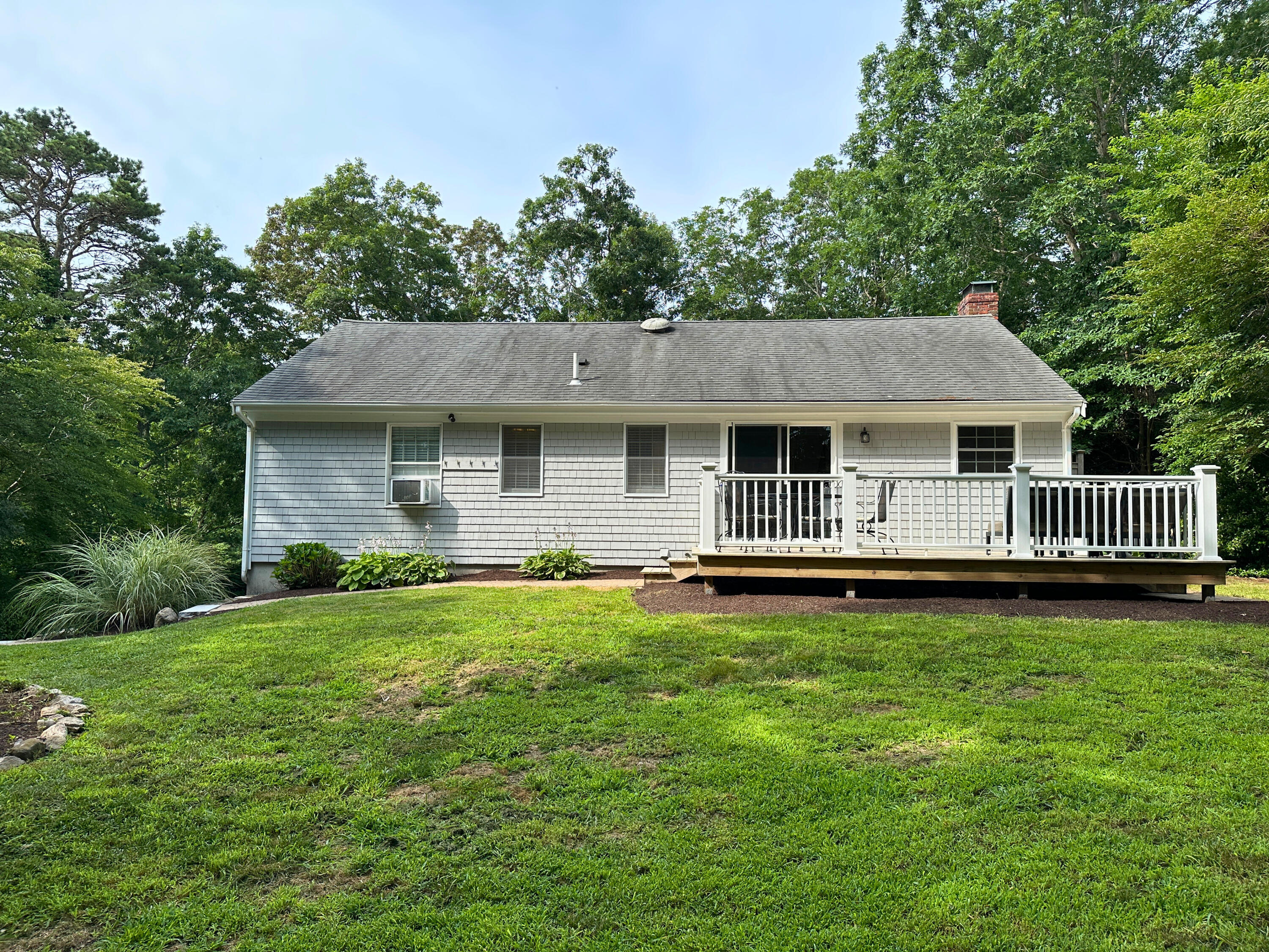 15 Surrey Lane Sandwich, MA 02563 - Photo 15 of 51 a front view of a house with a garden
