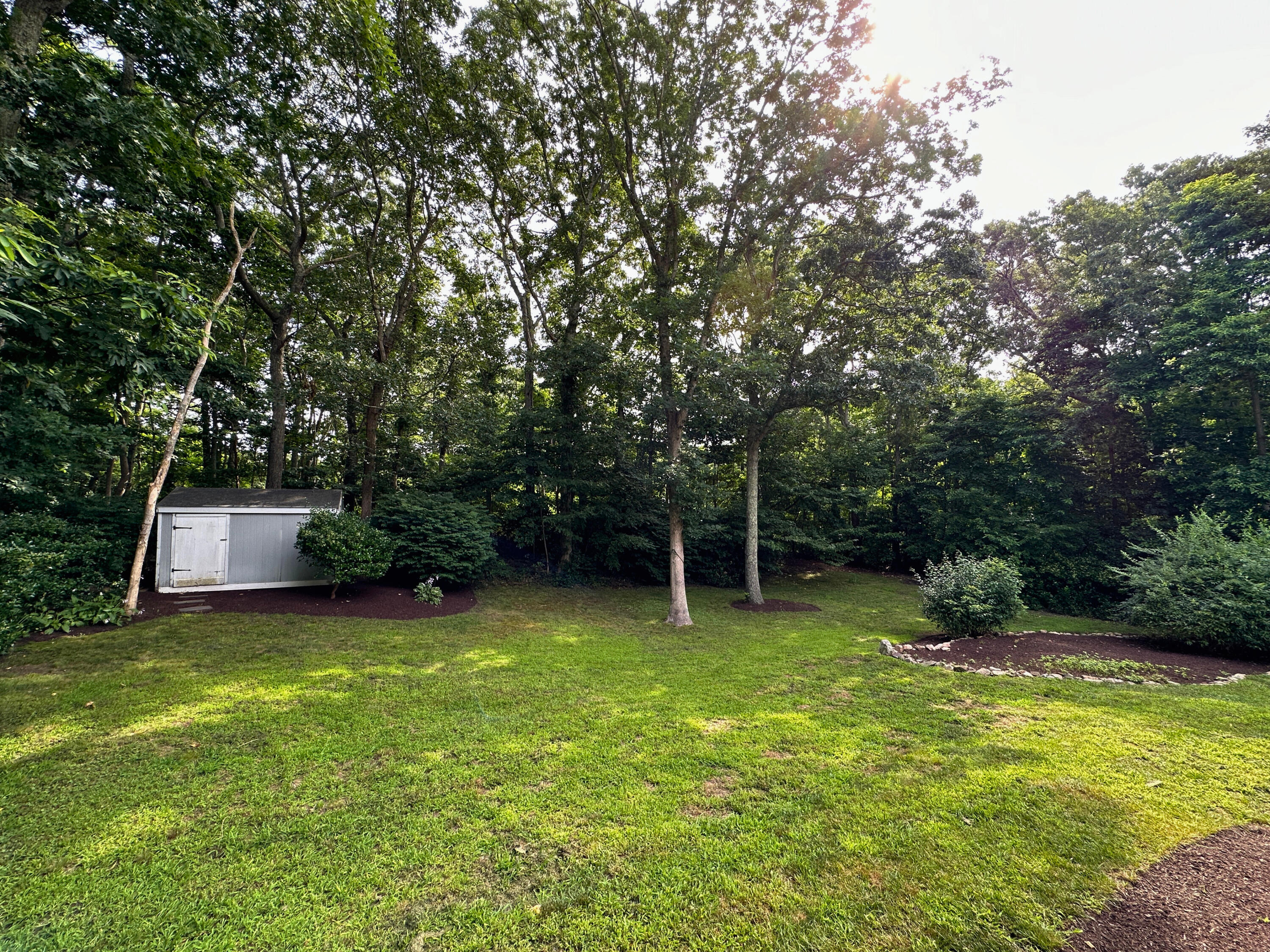 15 Surrey Lane Sandwich, MA 02563 - Photo 18 of 51 a view of a backyard with a small cabin