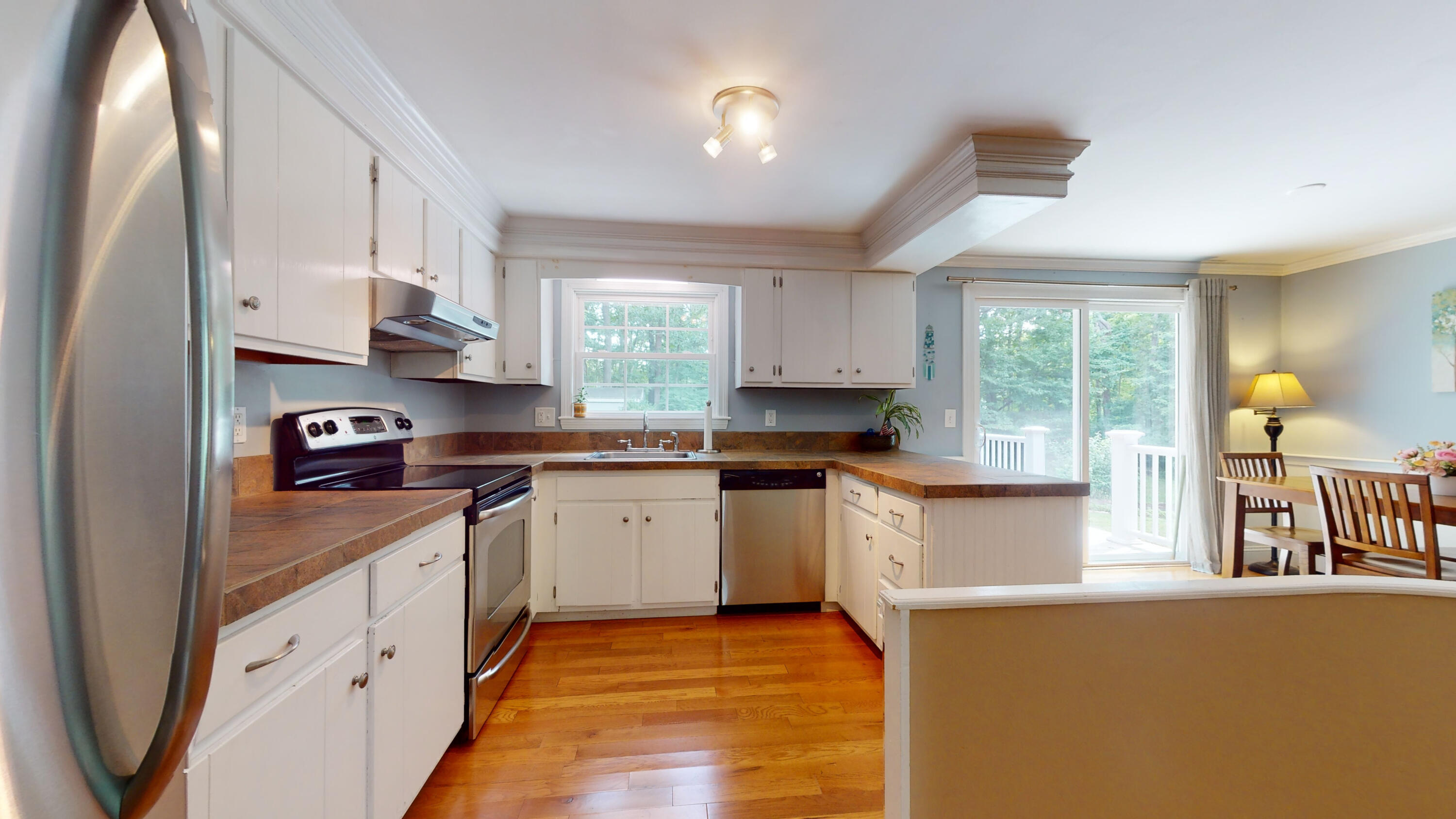 15 Surrey Lane Sandwich, MA 02563 - Photo 30 of 51 a kitchen with stainless steel appliances granite countertop a stove a sink and a granite counter tops with white cabinets