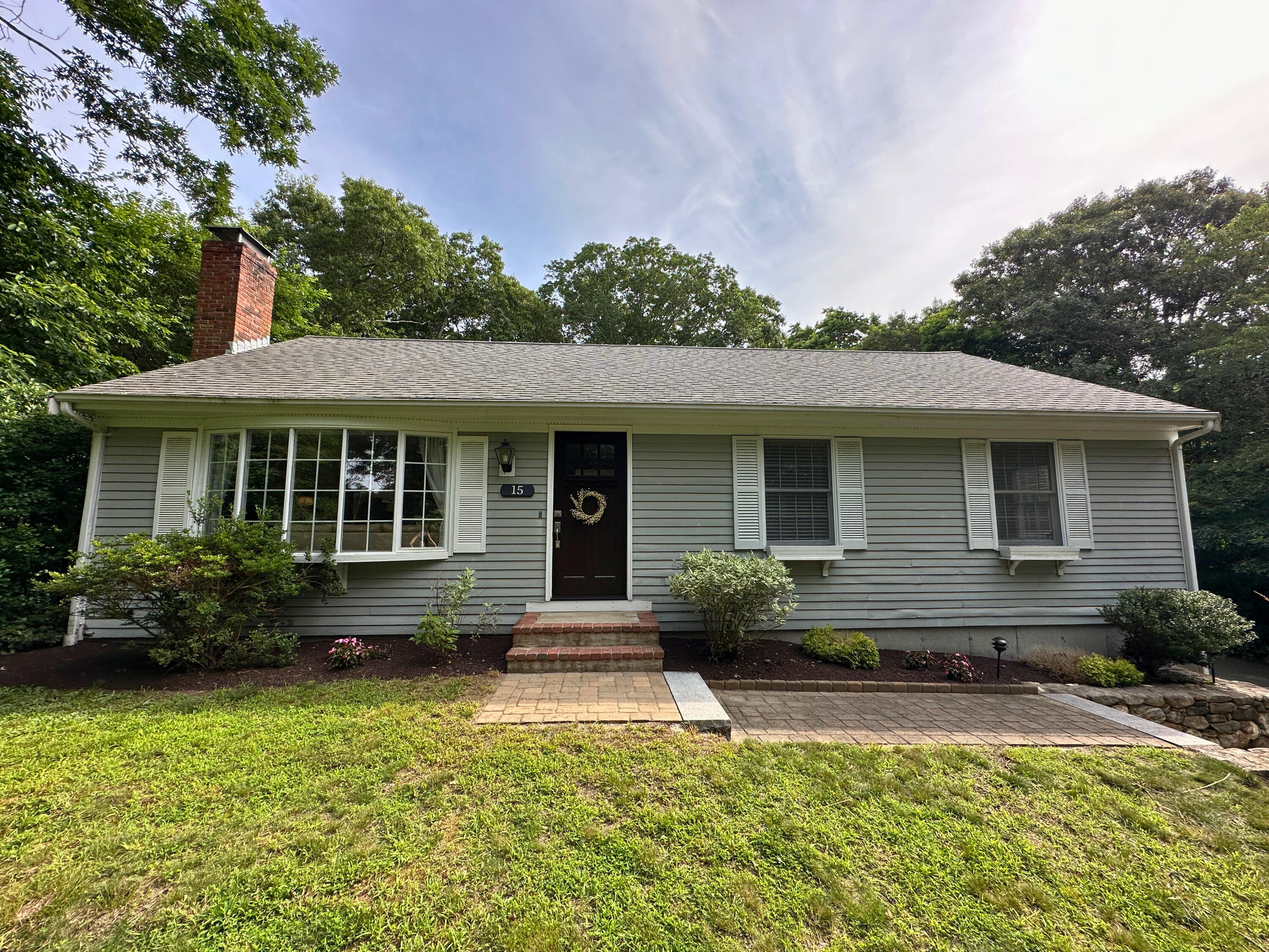 15 Surrey Lane Sandwich, MA 02563 - Photo 3 of 51 a front view of a house with a yard and porch