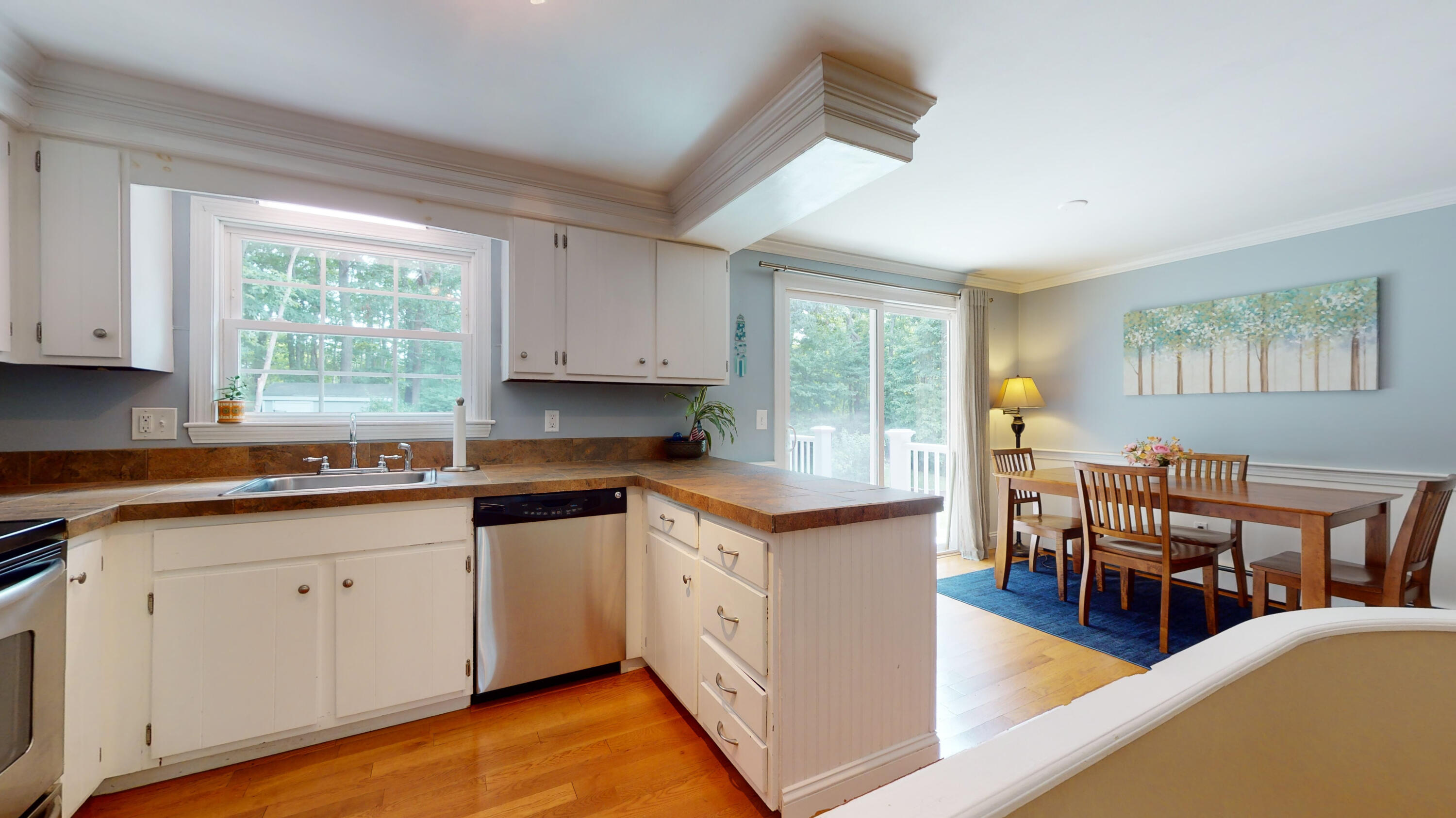 15 Surrey Lane Sandwich, MA 02563 - Photo 31 of 51 a kitchen with stainless steel appliances granite countertop a stove top oven a sink dishwasher and white cabinets with wooden floor