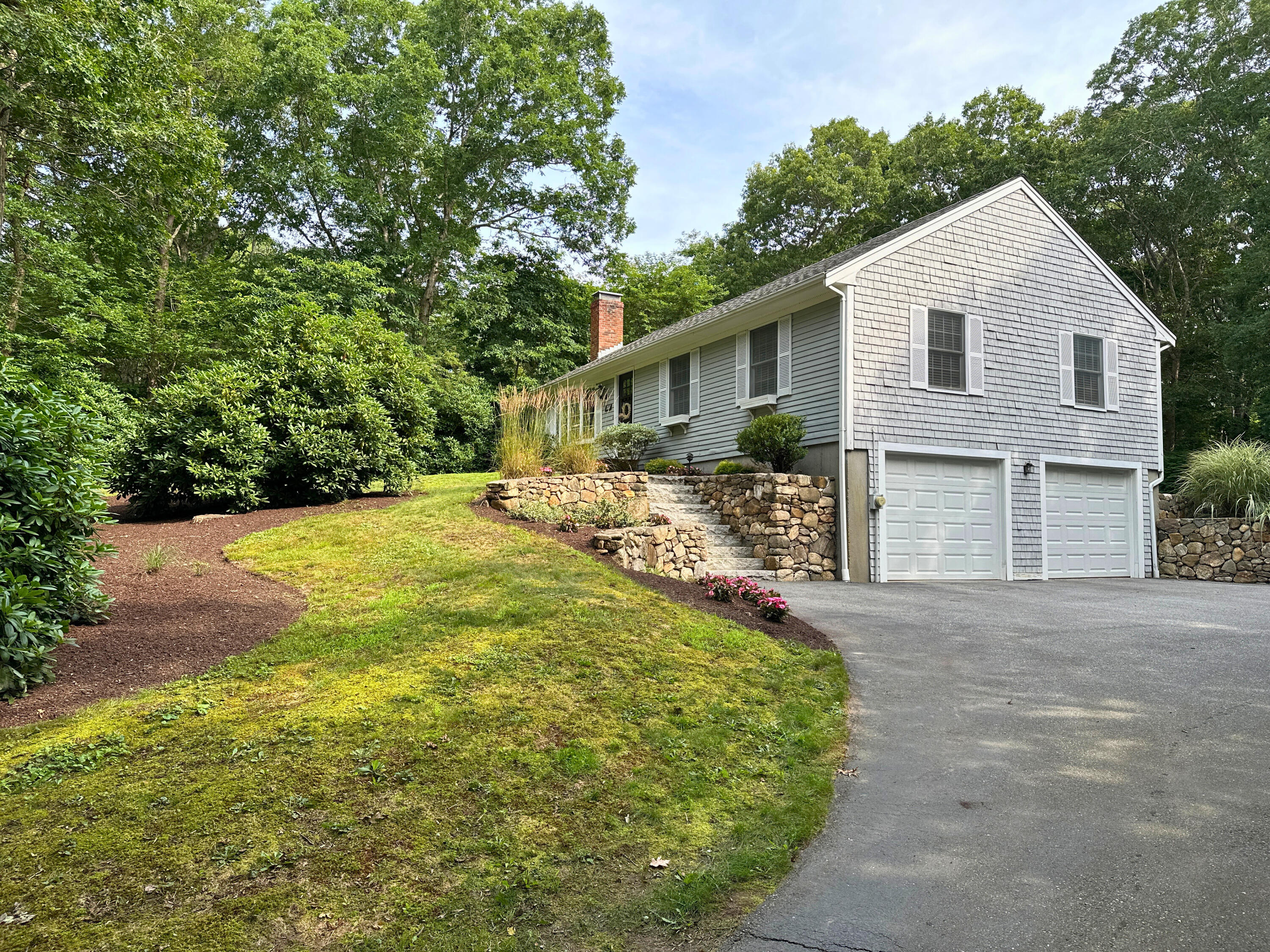 15 Surrey Lane Sandwich, MA 02563 - Photo 4 of 51 a view of a yard in front of a house with large trees