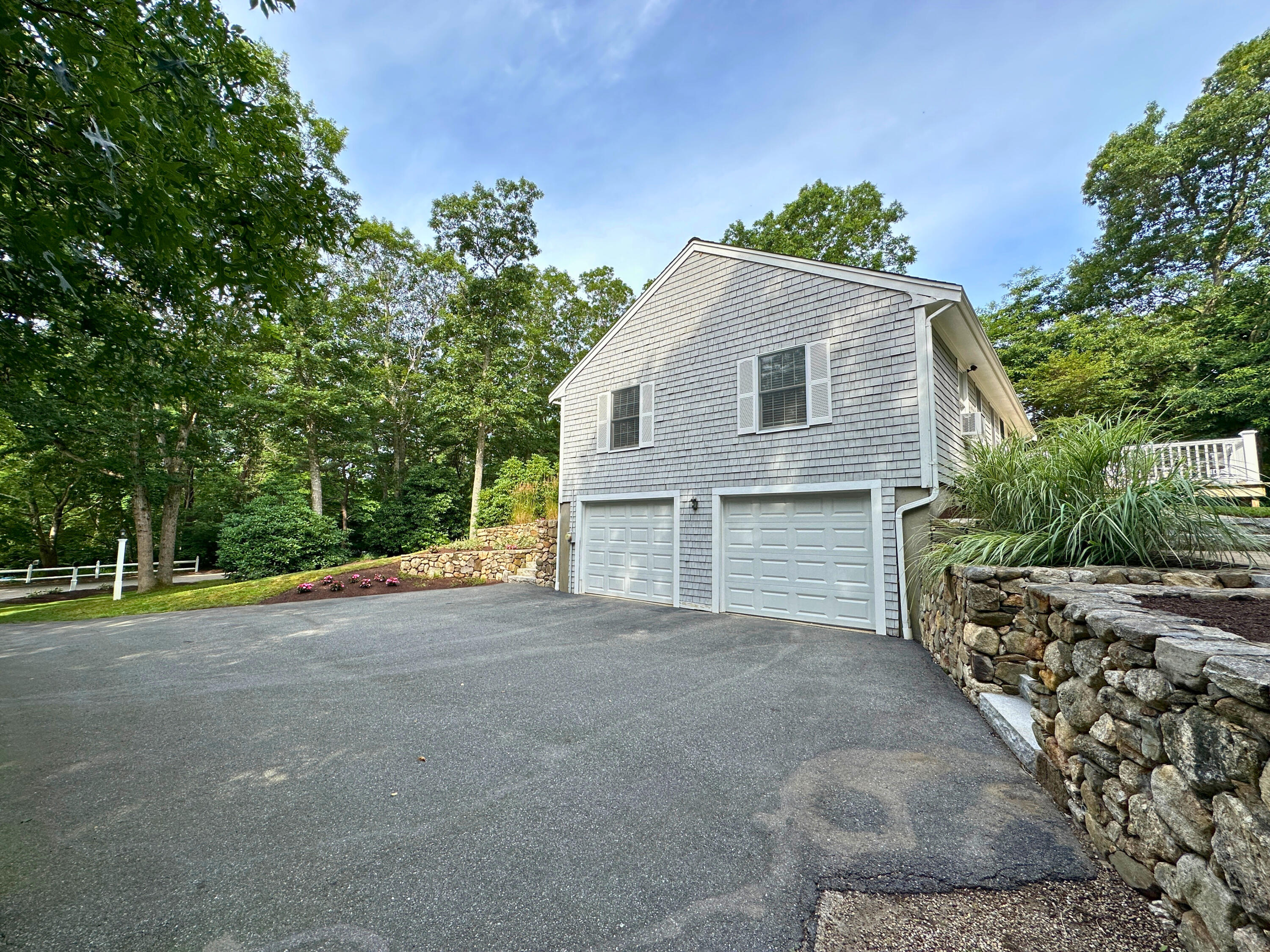 15 Surrey Lane Sandwich, MA 02563 - Photo 5 of 51 a front view of a house with a yard and garage