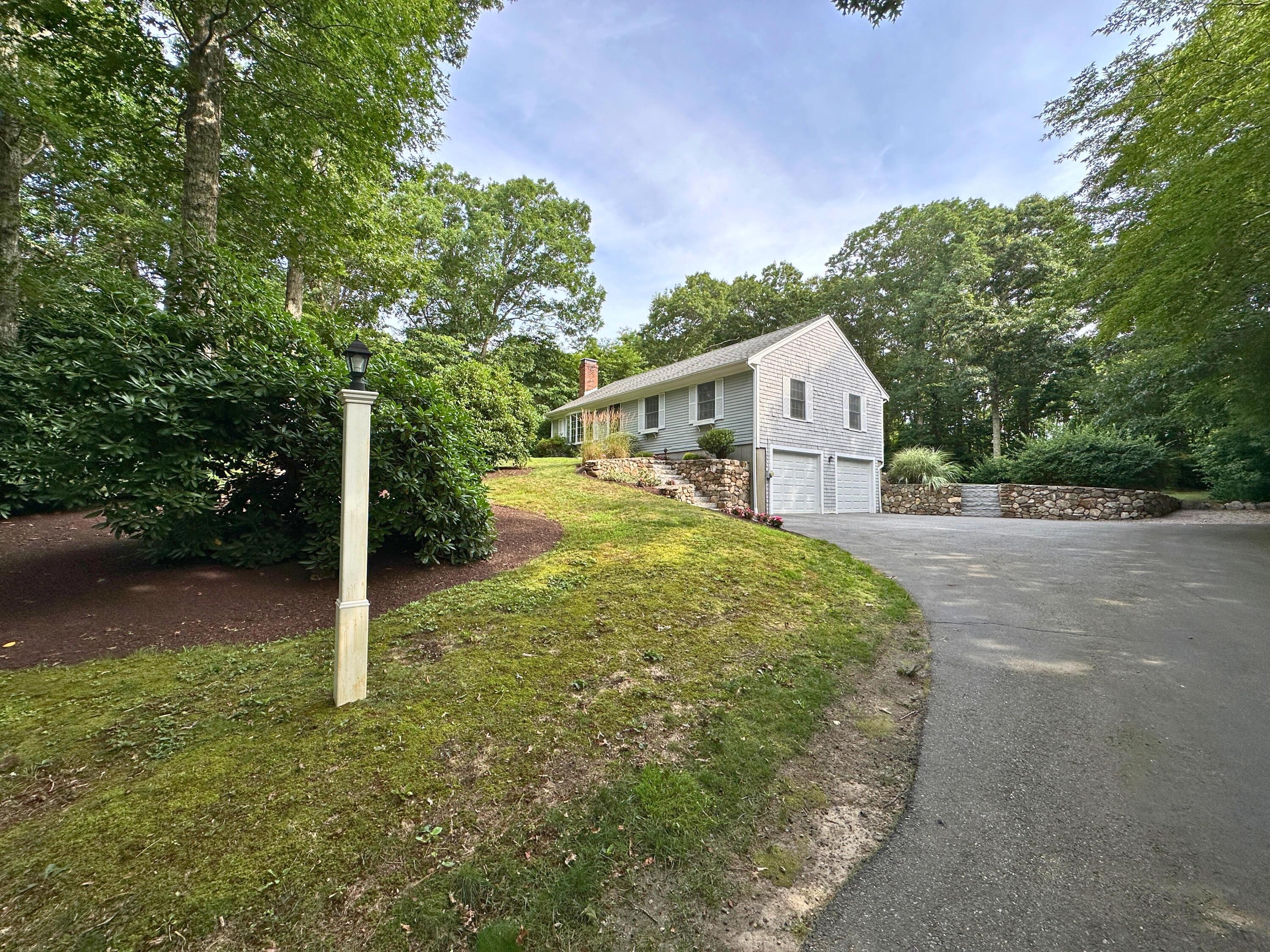 15 Surrey Lane Sandwich, MA 02563 - Photo 7 of 51 a front view of a house with a yard and garage
