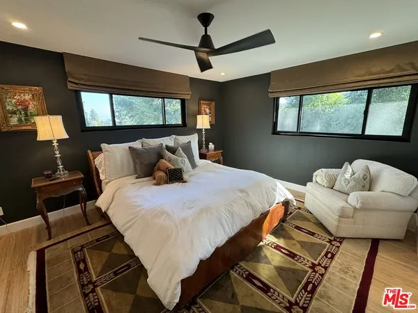 a bedroom with a bed and glass walk in closet