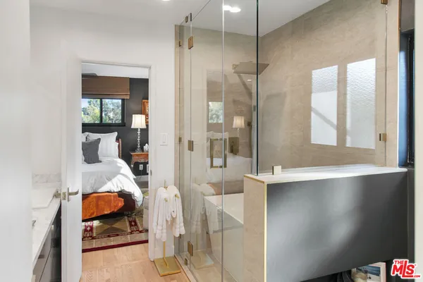 a bedroom with a bed and a chandelier