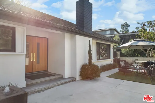 a front view of a house with outdoor seating