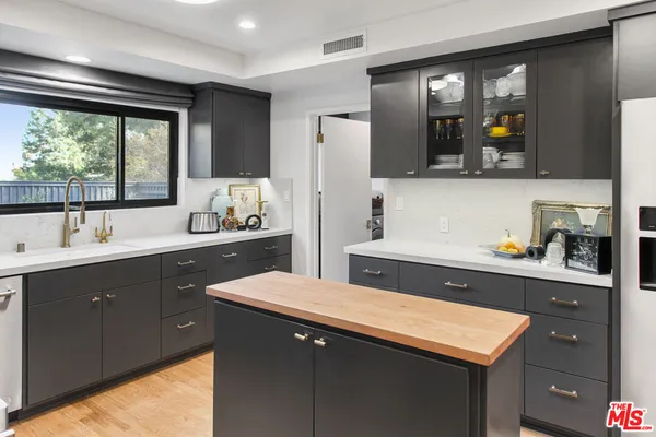 a kitchen with a sink and large window