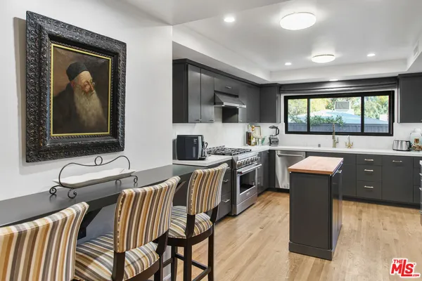 a kitchen with a sink and wooden cabinets