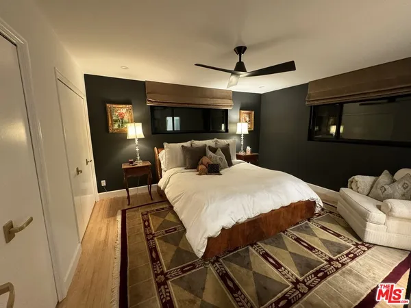 a bedroom with a bed and a mirror