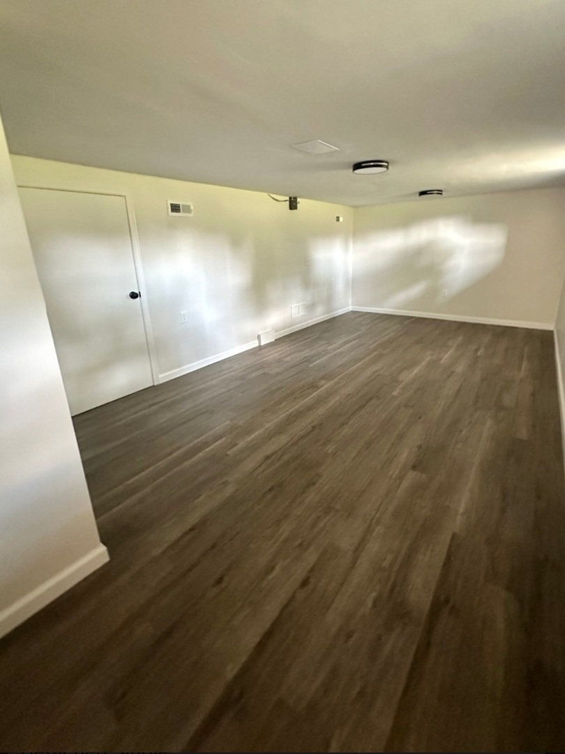 906 West Walnut Street Kankakee, IL 60901 - Photo 12 of 14 a view of an empty room with wooden floor