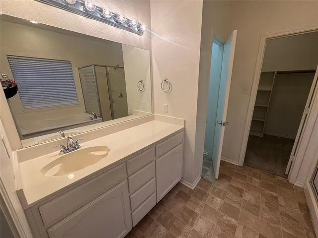 a bathroom with a double vanity sink and mirror