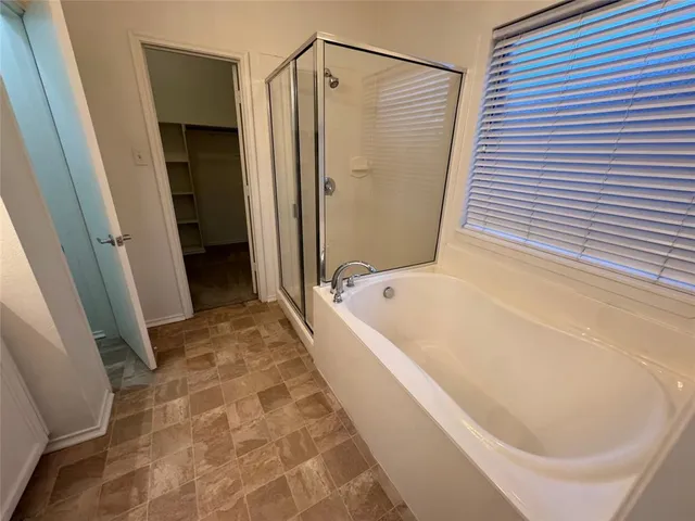 a bathroom with a bathtub and a shower