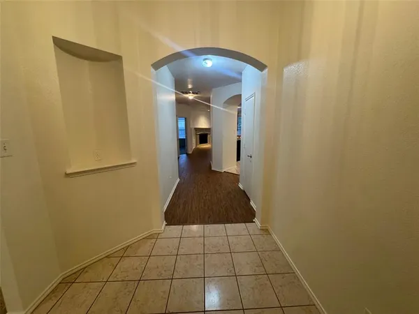 a walk in closet with wooden floor