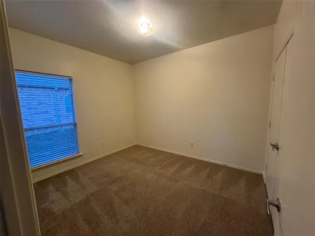 an empty room with a wooden door