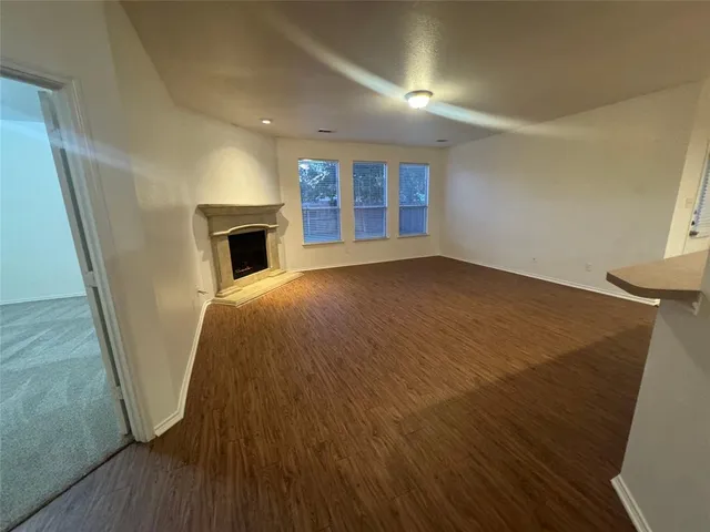 wooden floor in an empty room with a fireplace