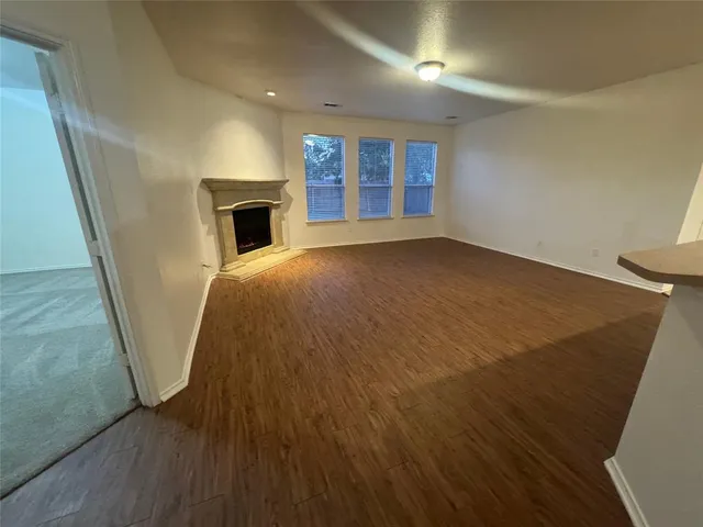 wooden floor in an empty room with a fireplace