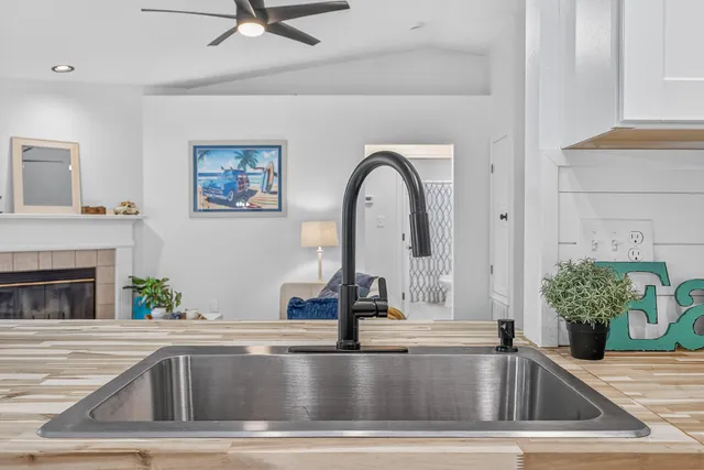 a dining room with wooden floor and a chandelier
