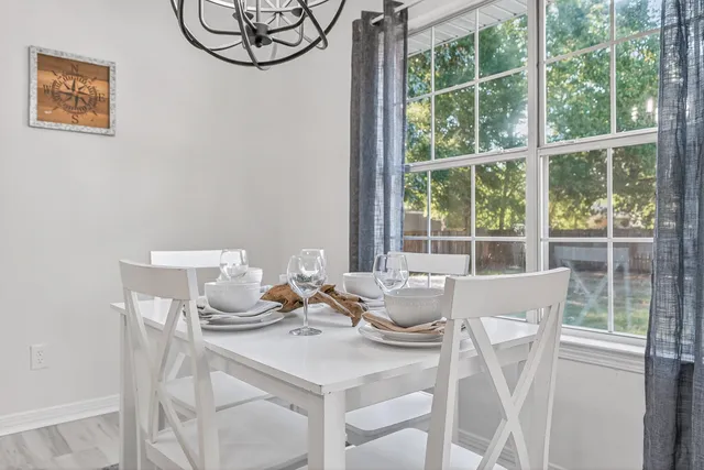 a view of a dining room with furniture window and wooden floor