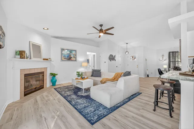 a living room with furniture and a dining table