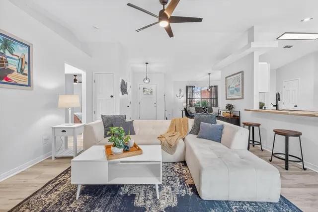 a living room with furniture and a potted plant
