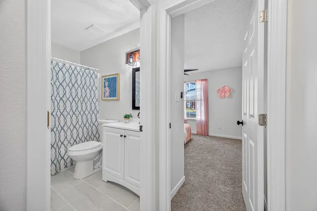 a large bedroom with a bed and a chandelier