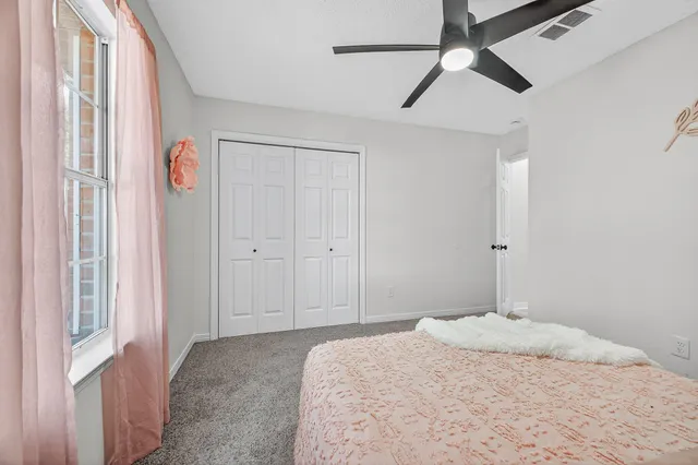 a bathroom with a toilet a sink a mirror and a shower