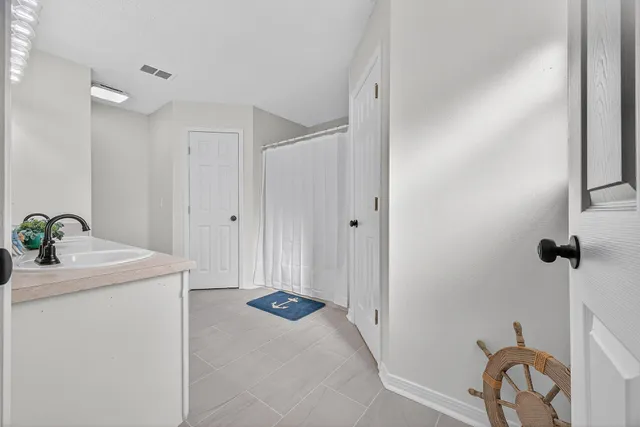 a bathroom with double vanity a mirror and a sink