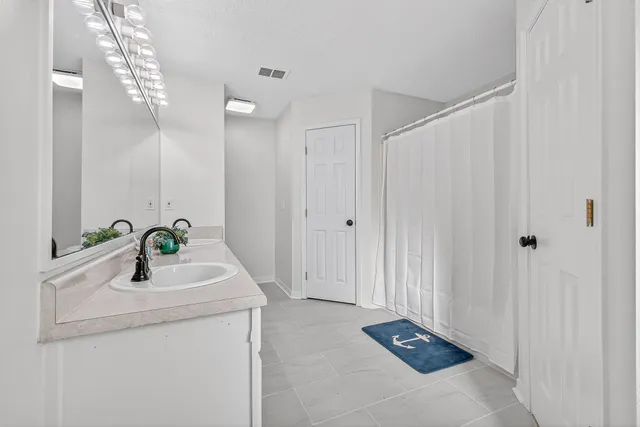 a bathroom with a double vanity sink and a mirror