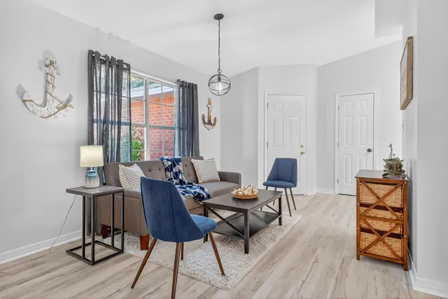 a view of a dining room with furniture window and wooden floor