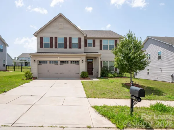 a front view of a house with a yard