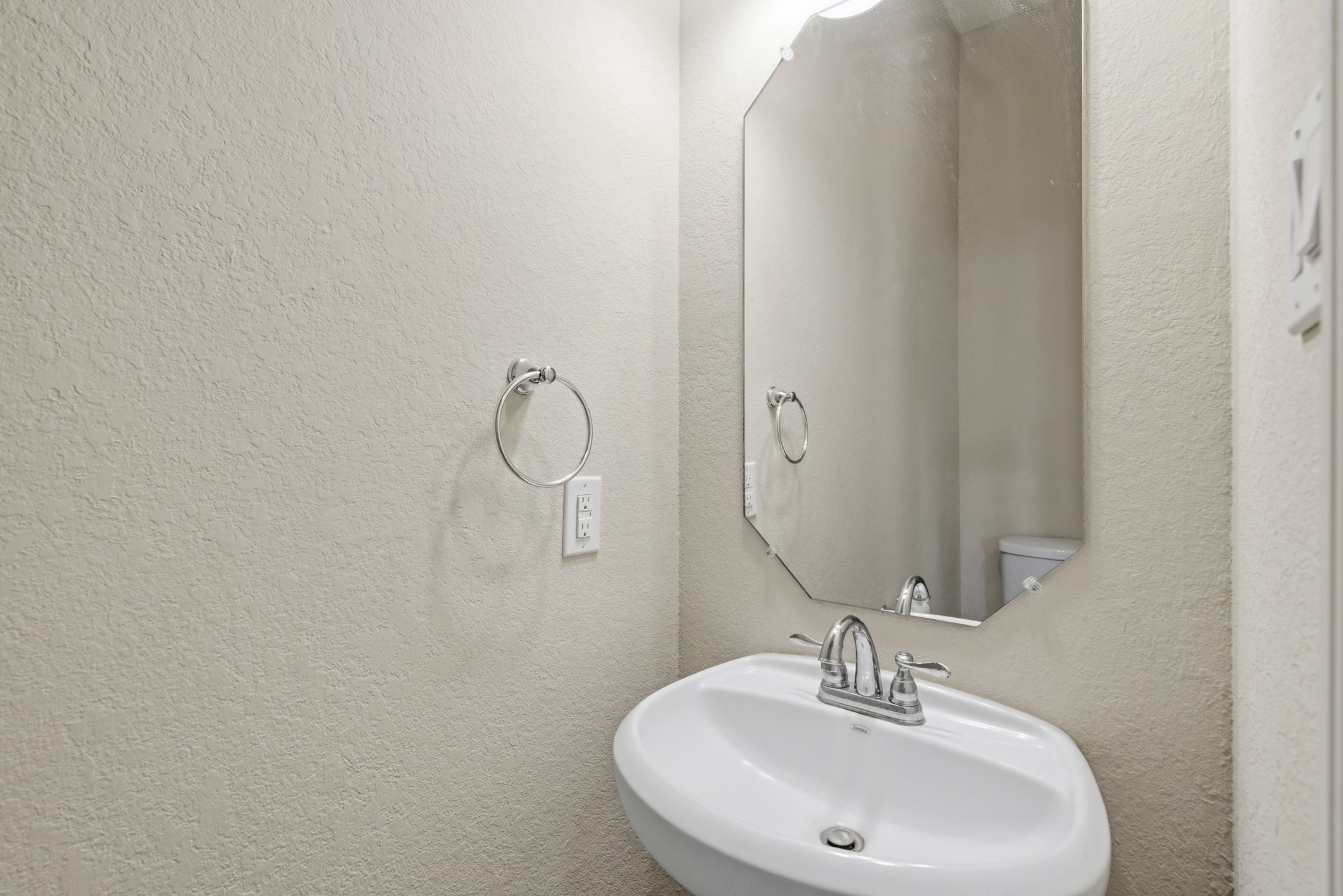 12115 San Luca Street Richmond, TX 77406 - Photo 19 of 44 Perfectly positioned for guests, the first-floor powder room adds convenience and functionality while maintaining the home's cohesive design aesthetic.